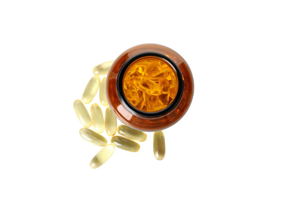 Brown bottle with omega pills, isolated on blank background