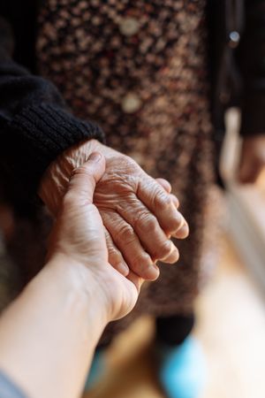 Man holding a mature woman's hand
