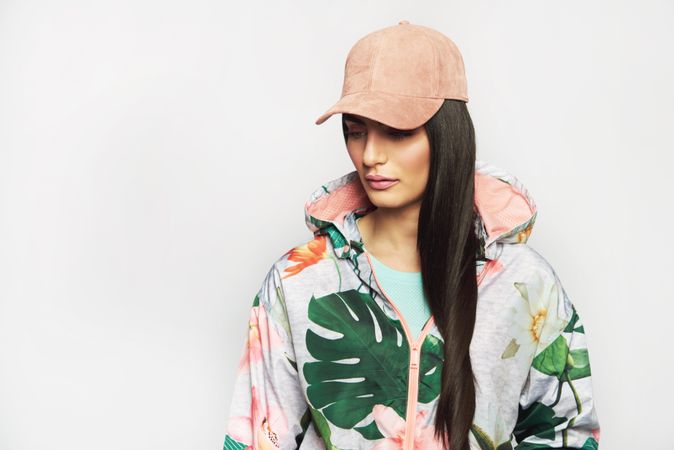 Beautiful woman pictured in colorful printed floral hoodie and cap