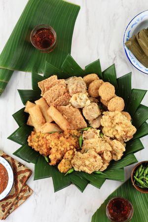 Top View Aneka Gorengan with Lontong, Green Chilli, and Peanut Sauce.