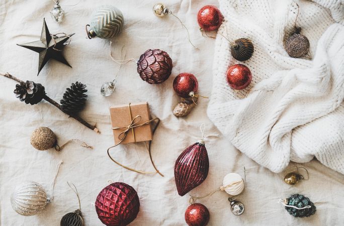 Flat-lay of holiday decoration, with knitted sweater, top view