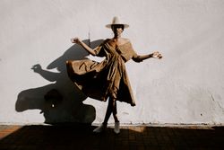 Woman wearing brown dress blowing in the wind
