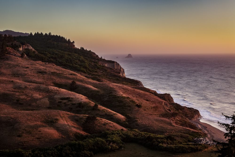 Top of rocky cliffs looking down at Pacific Ocean