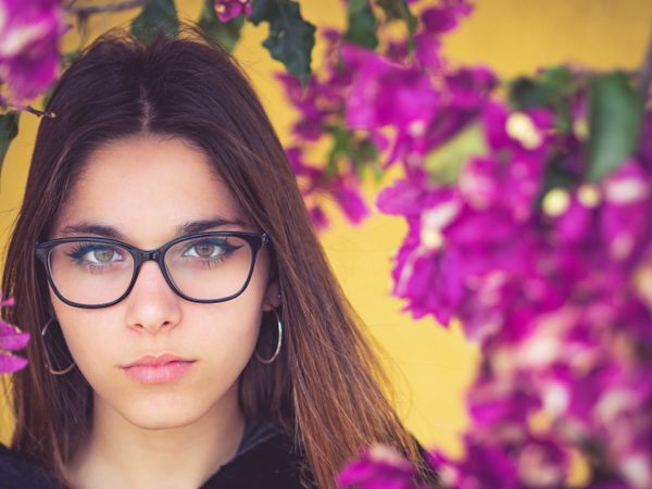 Woman on background of stunning violet flowers