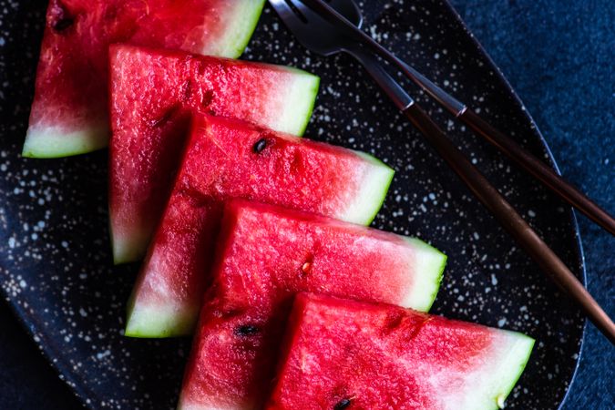 Looking down at watermelon slices arranged on plate