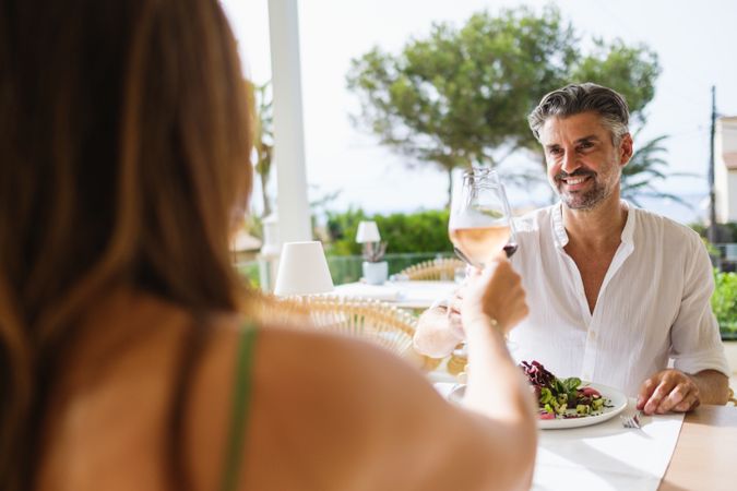 Happy couple clinking wineglasses during date