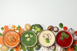 Row of colorful soups on bottom of picture with copy space