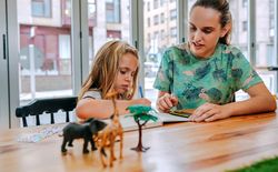 Mother and daughter drawing together