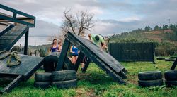 Participants in obstacle course climbing wall