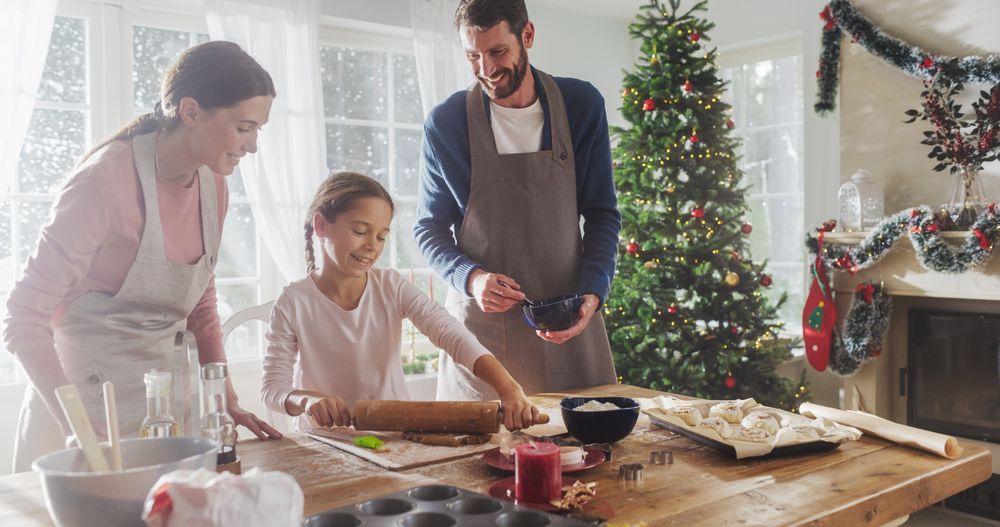 Portrait of Little Cute Girl Learning How to Make Cookies and Celebrating her Achievement with her Parents.