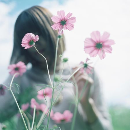 Woman near pink flowers