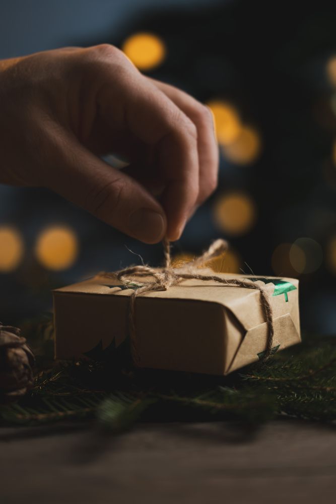 Man holding Christmas gift in hands