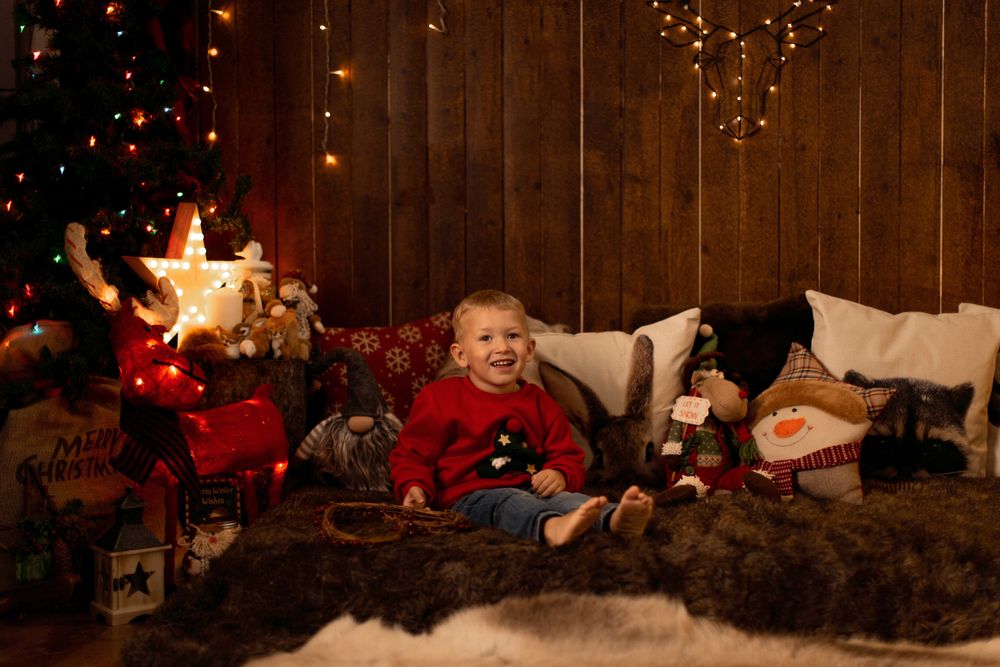 Little boy surrounded by christmas decoration