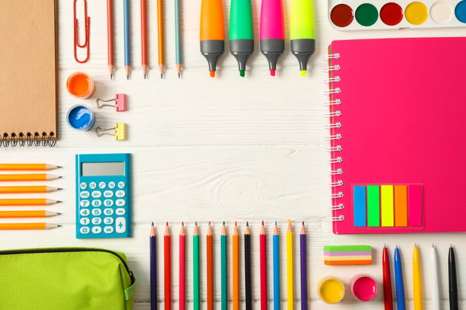 Flat lay composition with school supplies on wooden background, space for text