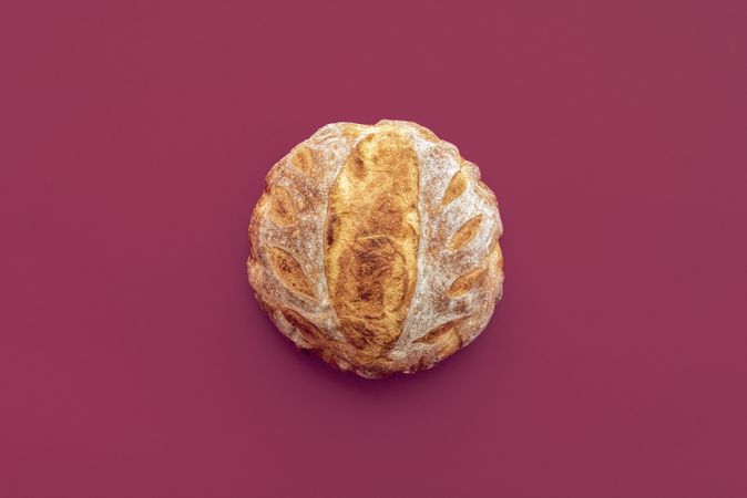 Homemade bread top view on a dark red background