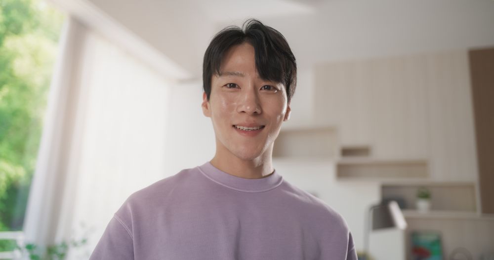 Close Up Portrait of a Korean Happy Young Male with Combed Hair Looking at Camera.