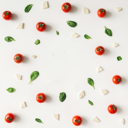 Basil, tomatoes, and cheese on light  background