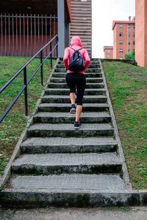 Female athlete going up stairs outdoors