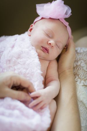 Hands of Woman Holding Her Newborn Baby Girl