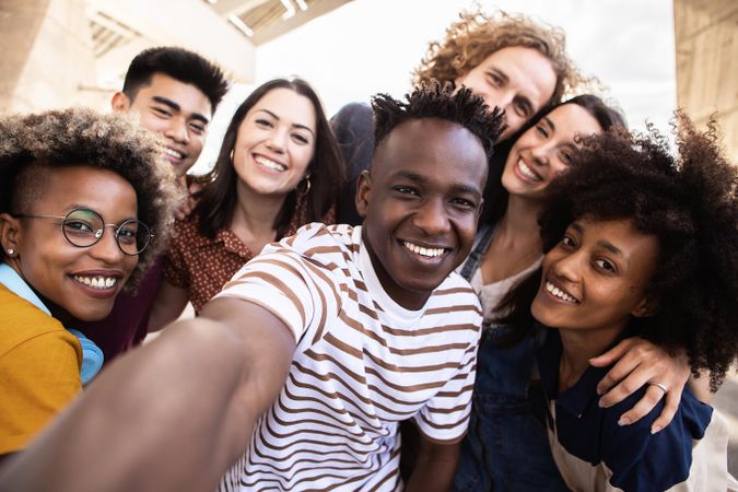 POV of group of happy people taking selfie together outdoors