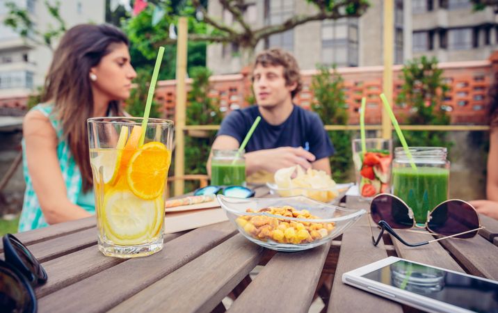 Snacks and drinks on outdoor table friends are enjoying