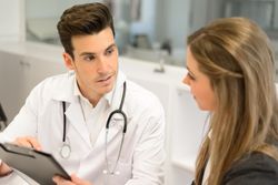 Doctor with female patient in clinic