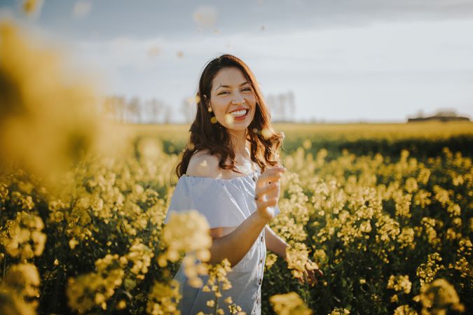 Woman with flowers in field