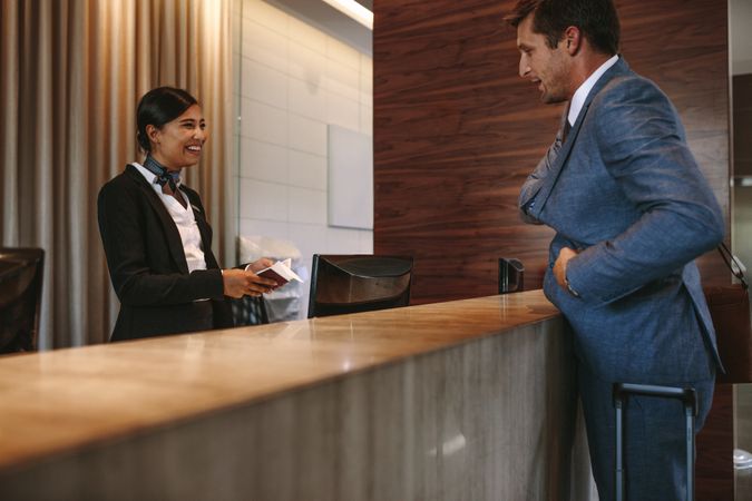 Businessman checking in at hotel reception