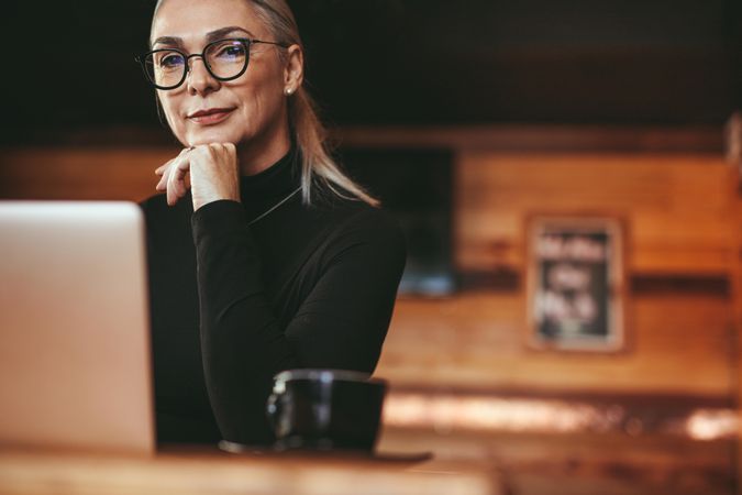 Businesswoman thinking while sitting at coffee shop
