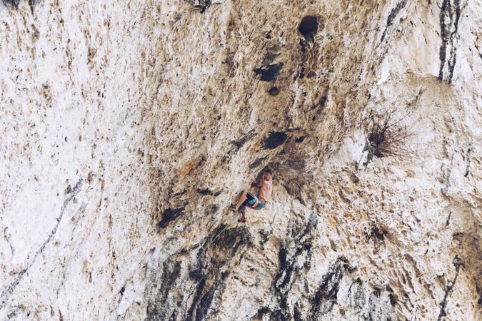 Anonymous man climbing rock