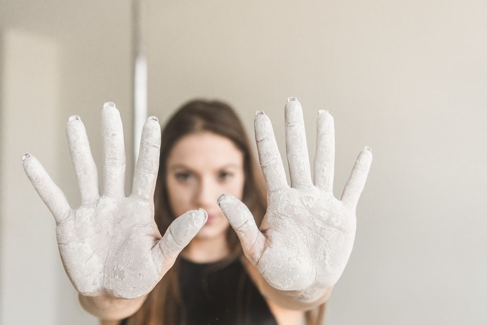 Young woman showing hands in chalk