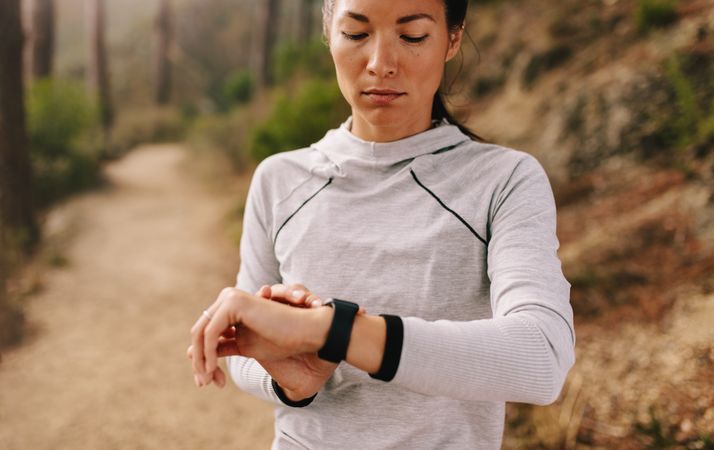 Asian female checking fitness progress on her smart watch