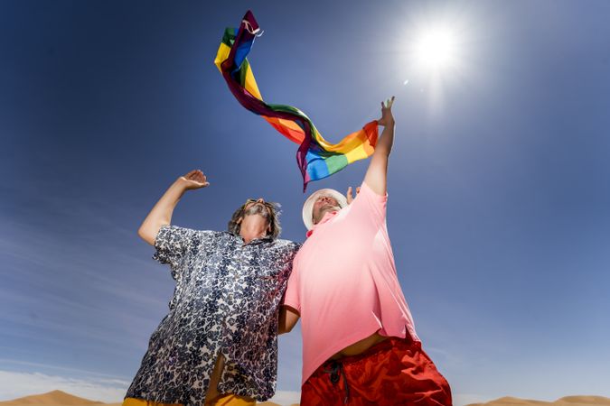 Excited gay couple in desert