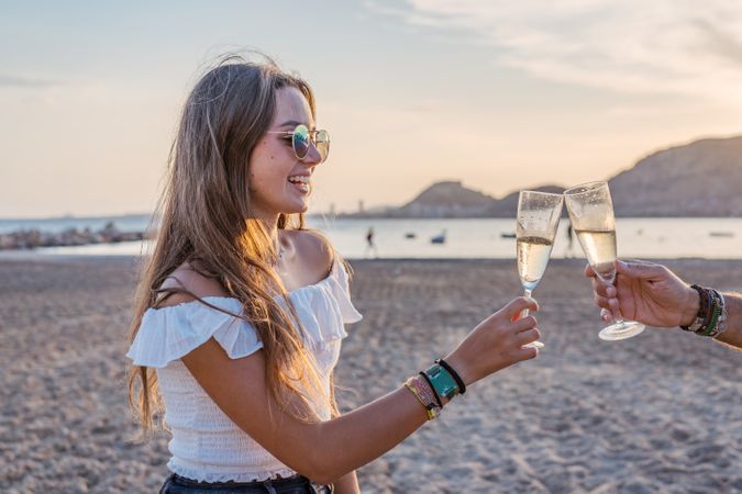 Happy family drinking wine on beach