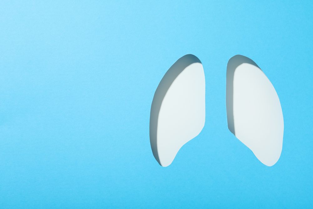 Blue paper with lung shape cut out with copy space