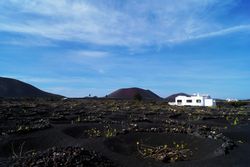 Picturesque view of volcanic terrain and white house