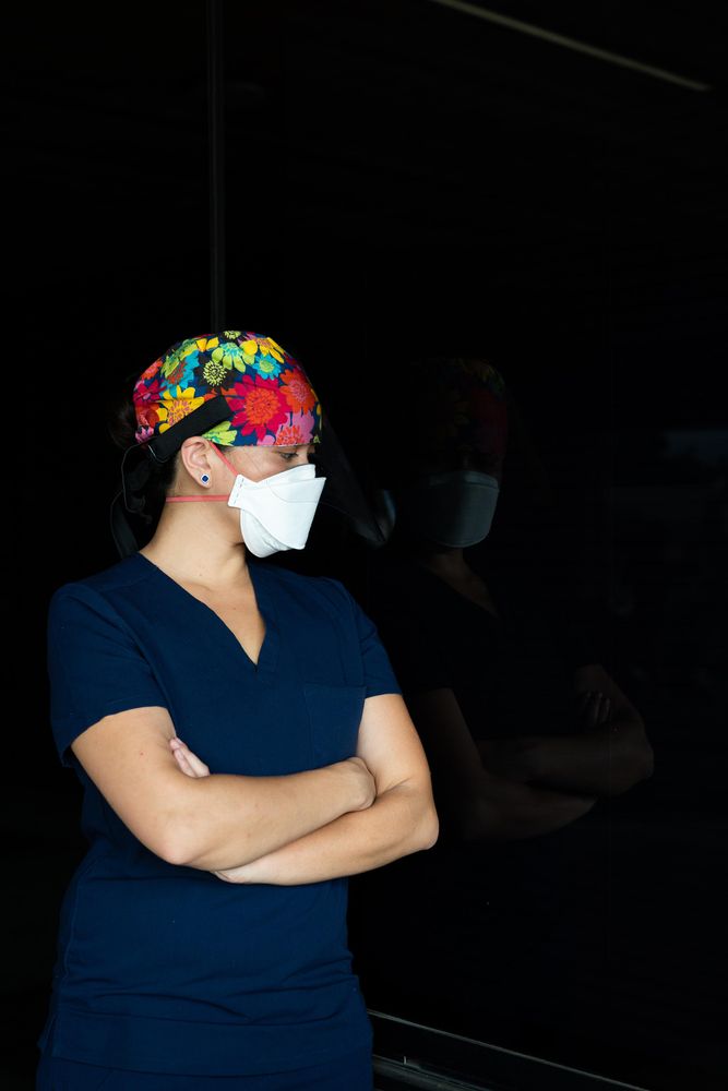 Portrait of woman nurse in PPS looking down with copy space