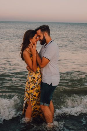 Loving couple embracing happily on sandy beach