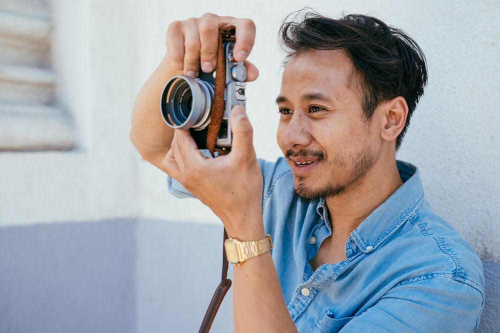 Man smiling while taking photo