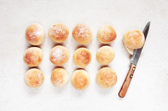 Freshly baked bread rolls with knife