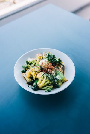 Bowl of broccoli with saffron on restaurant table