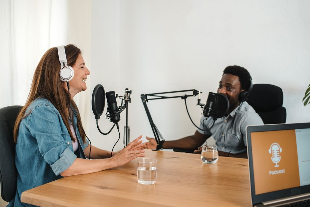 Multiethnic colleagues recording podcast in studio