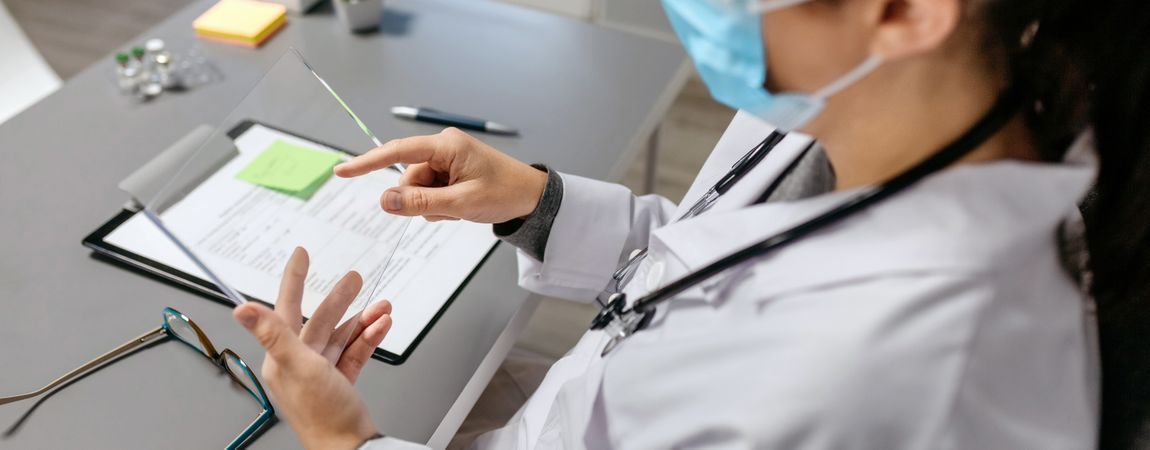 Female doctor working with transparent tablet