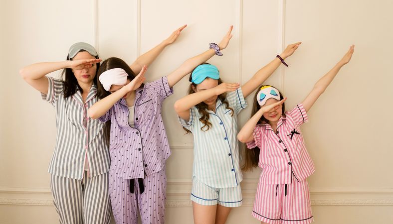Group girls in pajamas doing dab pose