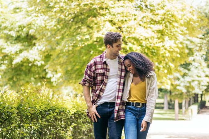 Happy multiracial couple taking a walk in the park