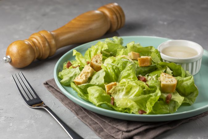 Caesar salad with croutons and bacon.