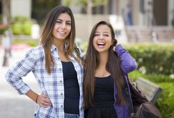 Female Students Carrying Backpacks on School Campus