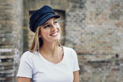 Portrait of woman in cap with copy space