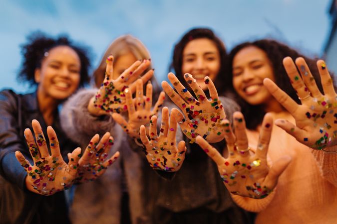 Group of woman with confetti on their hands