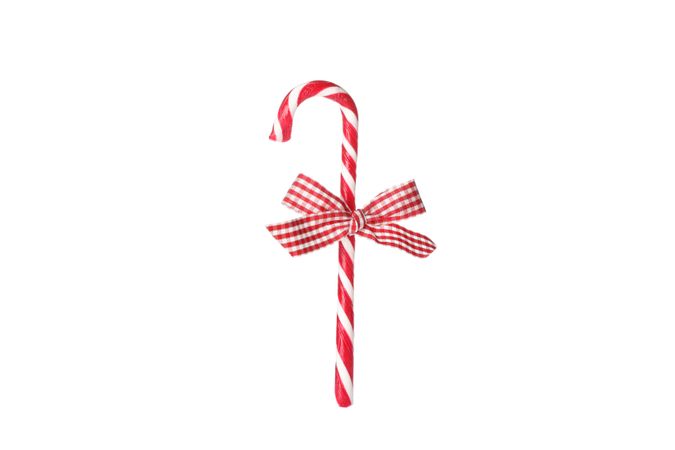 Sweet candy cane with bow isolated on plain background